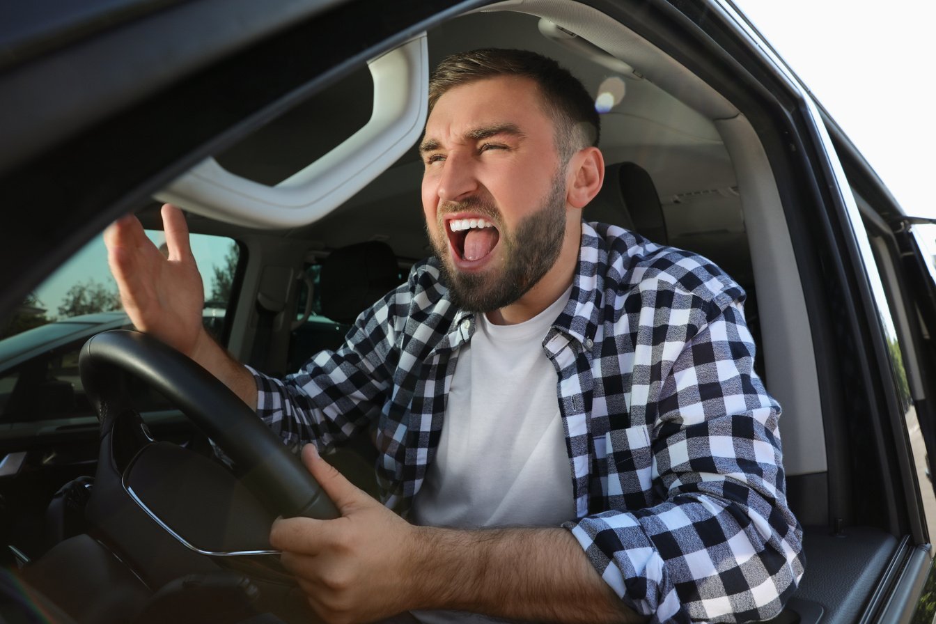 Emotional Man in Car. Aggressive Driving Behavior